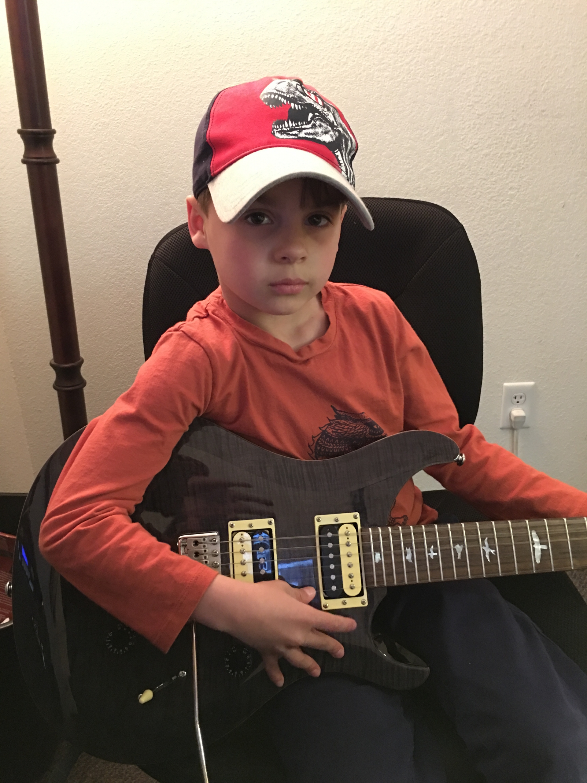 Getting ready to perform  on his guitar at the talent show