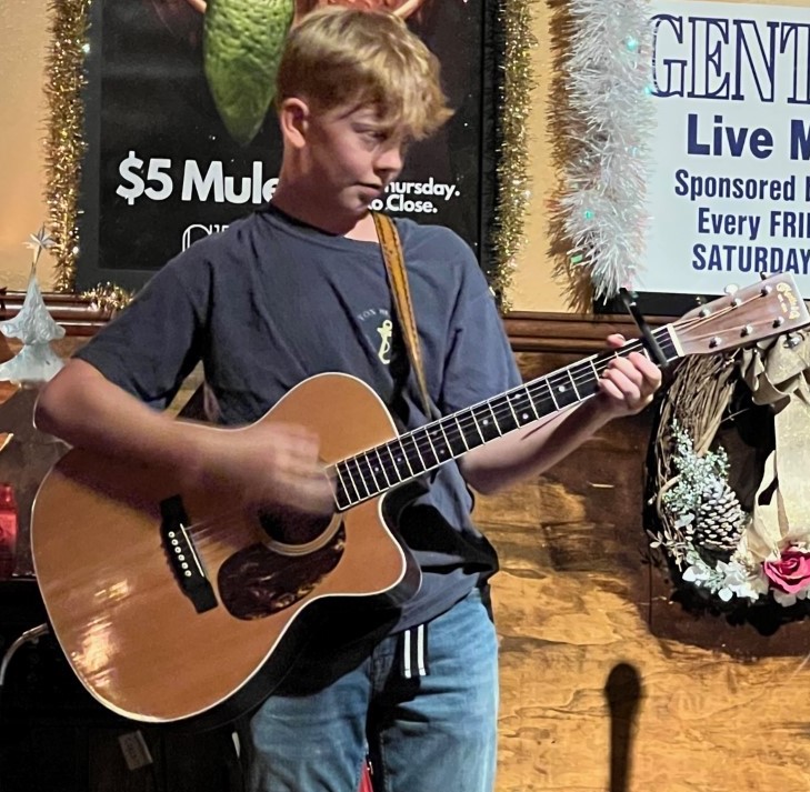 Jackson performing at the open mic night in downtown Greeley