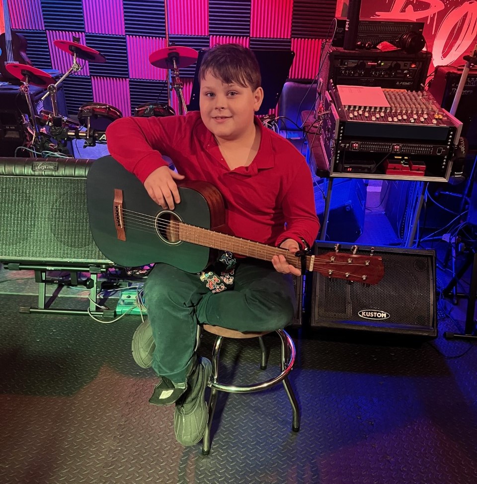 Jude preparing for a guitar lesson at the Greeley studio