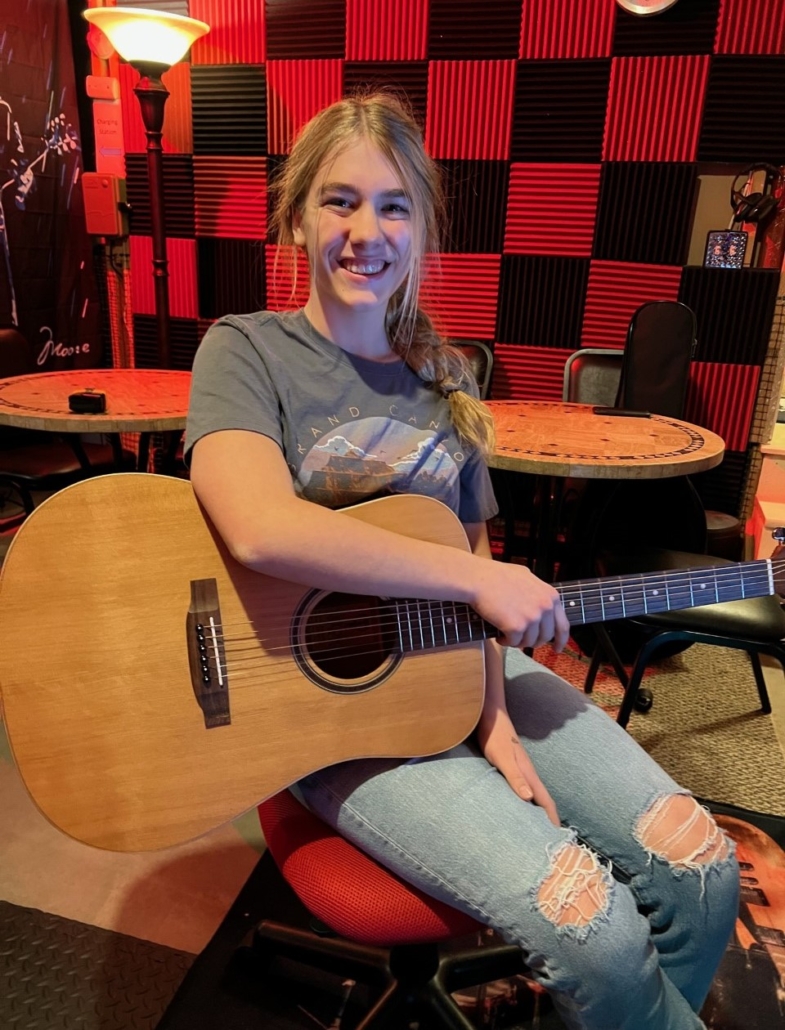 Madeline taking a "guitar lesson near me"